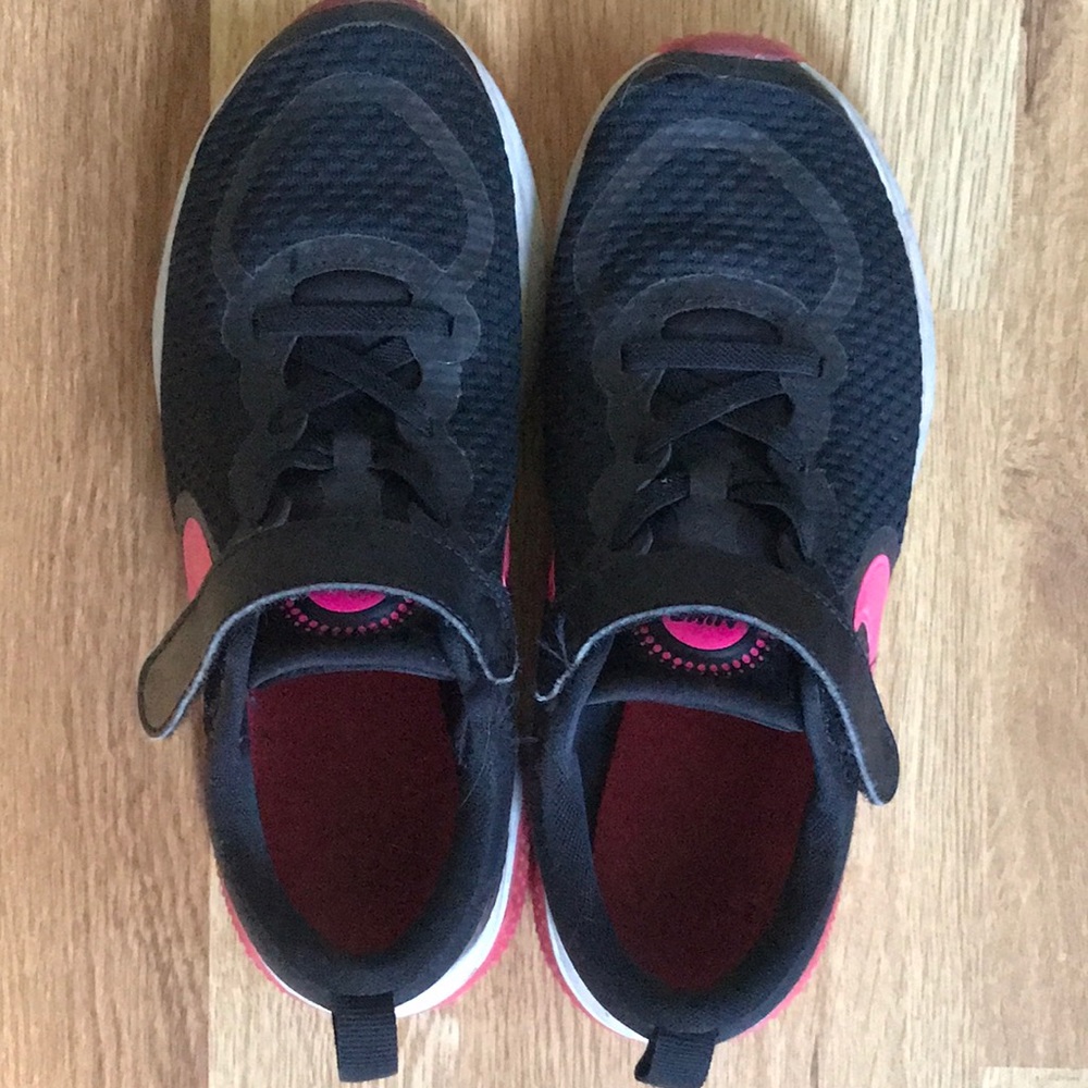 Black and pink kids Nike shoes